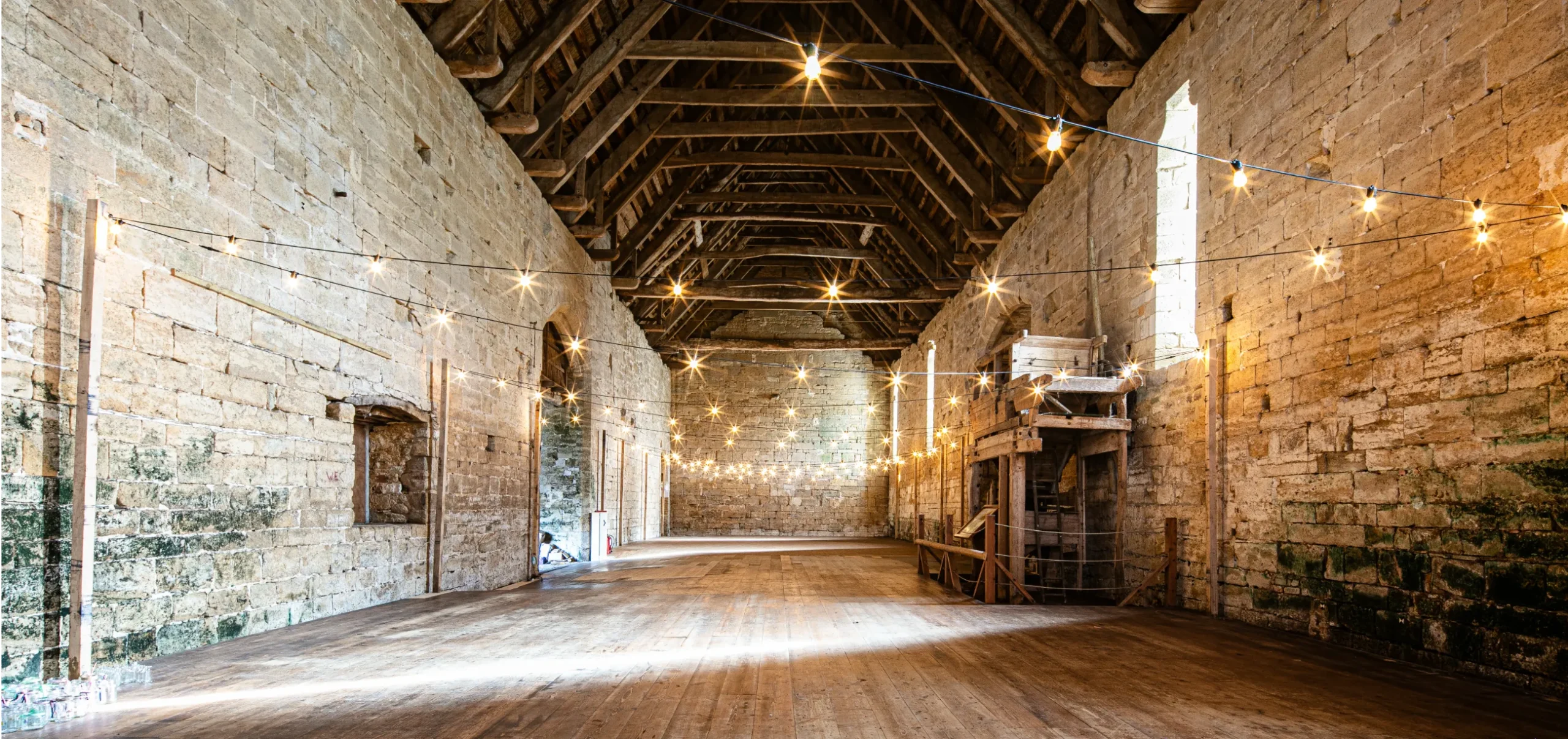 Festoon lights inside an old barn