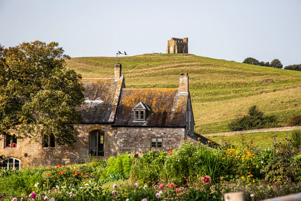 abbotsbury on a hill with a farm house in front of it