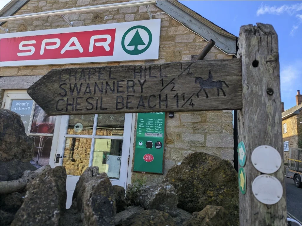 Wooden sign post in front of spar